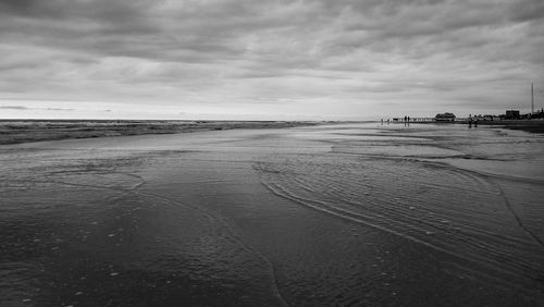 View of beach against cloudy sky