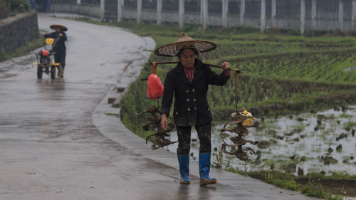 People walking on road during rainy season