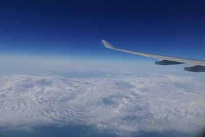 Cropped image of airplane flying over landscape