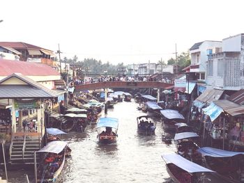 Boats in city against clear sky