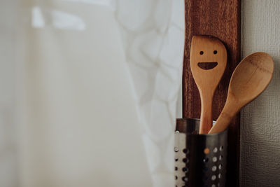 Close-up of paintbrushes hanging on wood at home