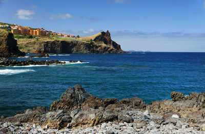 Rocky coastal feature along calm blue sea