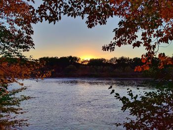 Scenic view of lake against sky during sunset