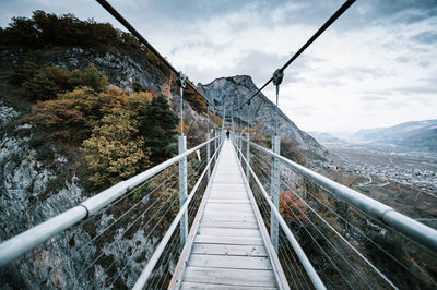 View of footbridge against sky