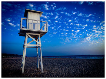 Lifeguard hut on beach against sky