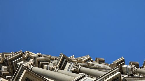Low angle view of buildings against clear blue sky