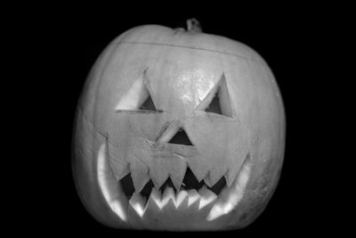 Close-up of illuminated pumpkin against black background