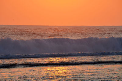 Scenic view of sea against orange sky