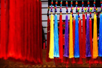 Close-up of multi colored tassels hanging at shop