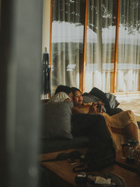 Portrait of a woman sitting on window