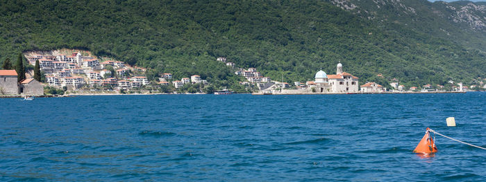 View of sea and buildings in town