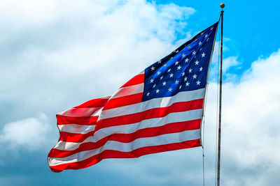 Low angle view of american flag against sky