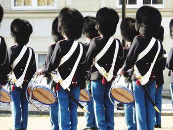 Rear view of people playing drum in ceremony