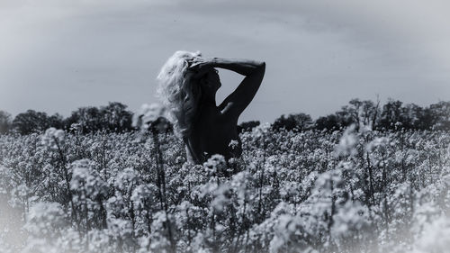 Rear view of woman standing on field