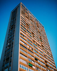 Low angle view of modern building against clear blue sky