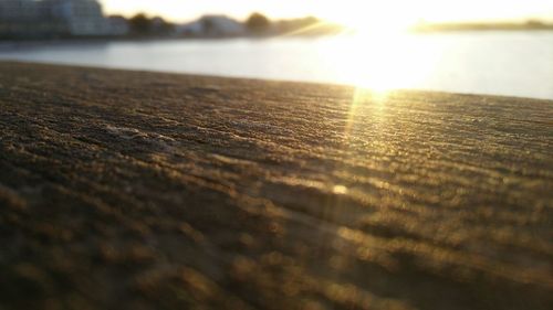 Surface level of sea against sunset sky