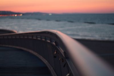 Cropped image of boat in sea at sunset