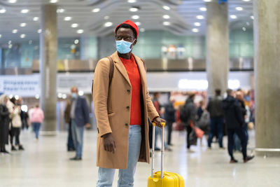 Man wearing mask standing at airport