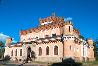 Low angle view of historical building against blue sky