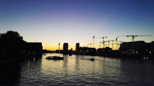 View of city at waterfront during sunset