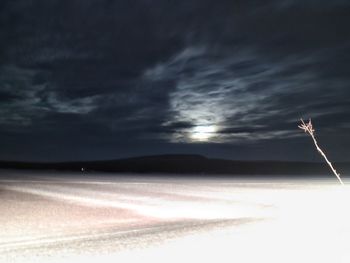 Storm clouds over snow covered landscape