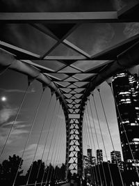 Low angle view of suspension bridge against sky