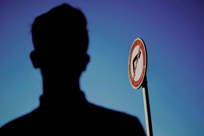 Low angle view of silhouette man against clear sky