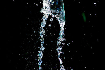 Close-up of water splashing against black background