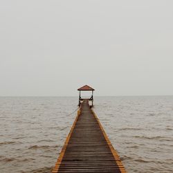 View of jetty leading to sea