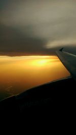 Cropped image of landscape against sky at sunset