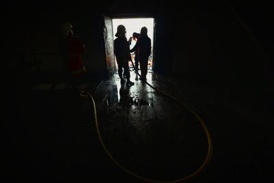 Silhouette men in corridor