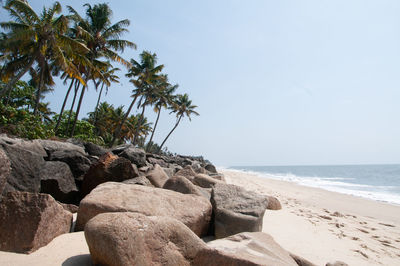 Scenic view of rocks on beach against sky