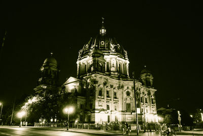 Low angle view of illuminated building against sky at night