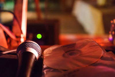 Close-up of microphone and disc on table 