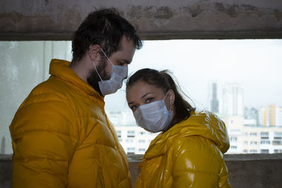 Portrait of young couple standing outdoors