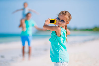 Boy with umbrella on beach