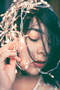 Close-up of woman with illuminated lights