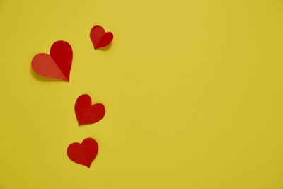 Close-up of heart shape against yellow background