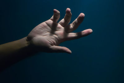 Close-up of human hand against gray background