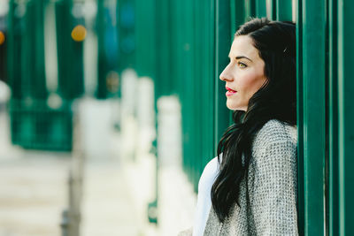 Portrait of young woman looking away outdoors