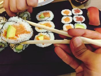 Midsection of person holding sushi
