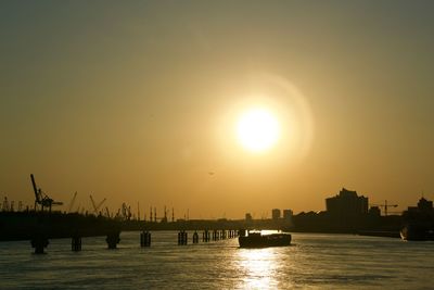 Scenic view of silhouette city against sky during sunset