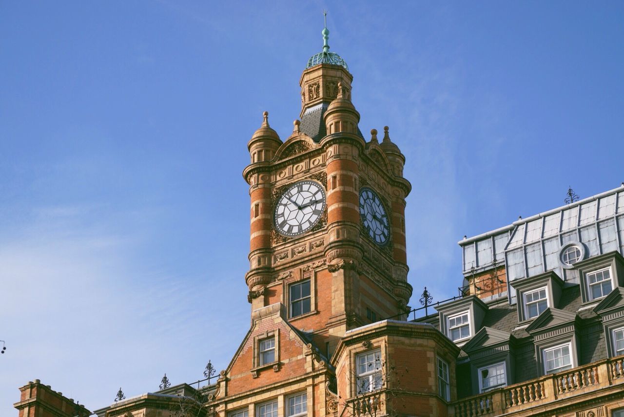 architecture, building exterior, built structure, low angle view, clear sky, tower, blue, sky, clock tower, church, history, religion, place of worship, day, tall - high, city, window, travel destinations, outdoors