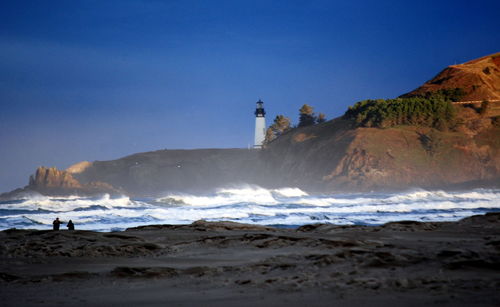 Scenic view of beach against clear blue sky