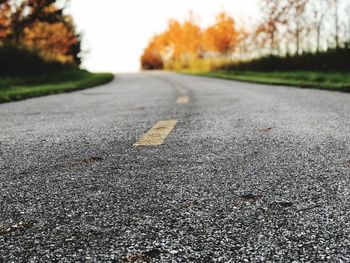 Close-up of road against trees during autumn