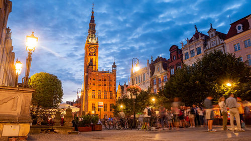 Group of people on street against buildings at night