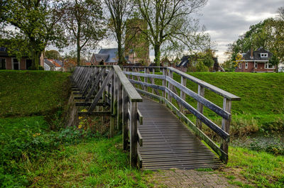 Wooden bridge for pedestrians crossing the moat which is part of the towns fortifications