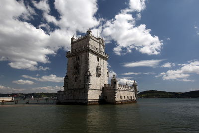 Torre de belem on tagus river against sky