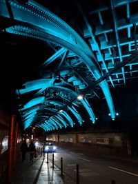 People walking in illuminated city at night