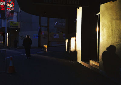 Woman standing in illuminated city at night